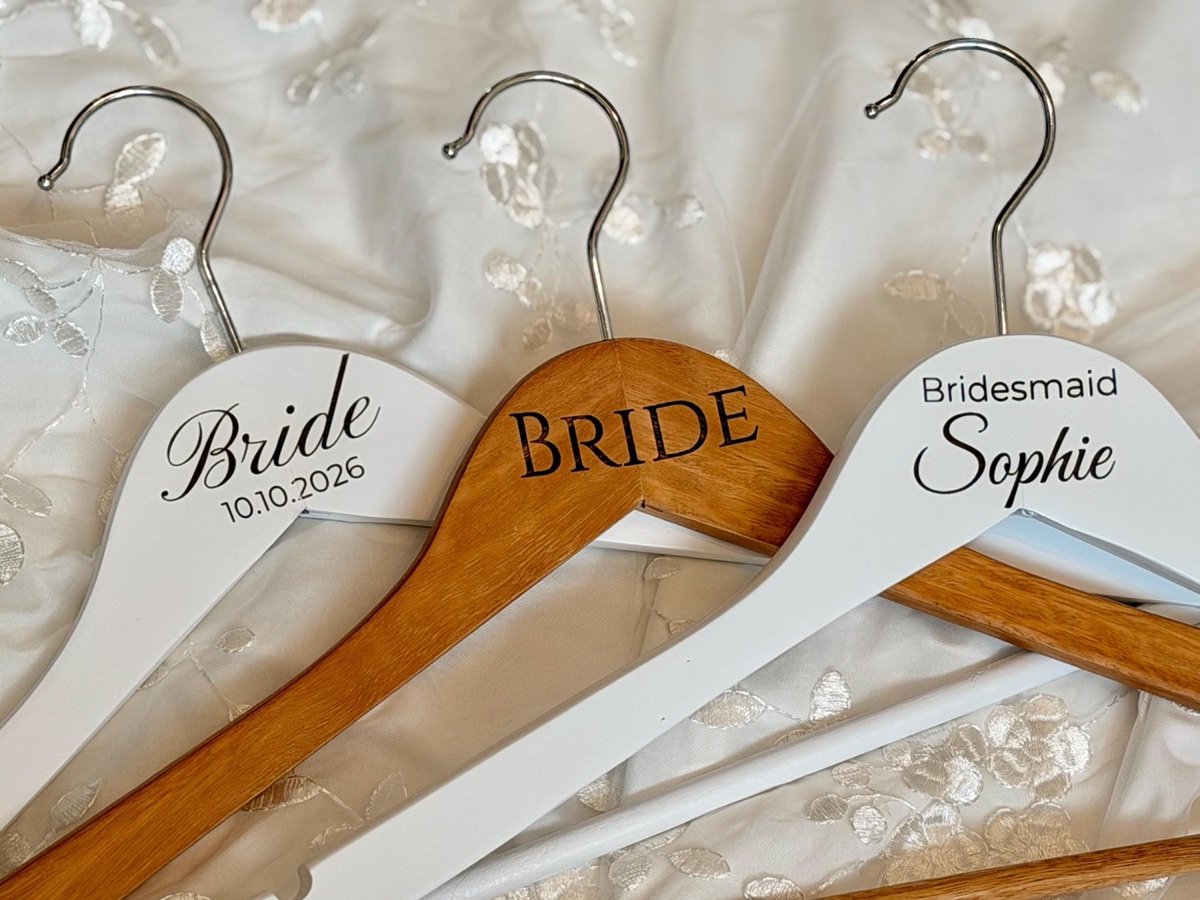 Three engraved wooden hangers on lace: Bride in white, BRIDE in eucalyptus, Bridesmaid Sophie in white
